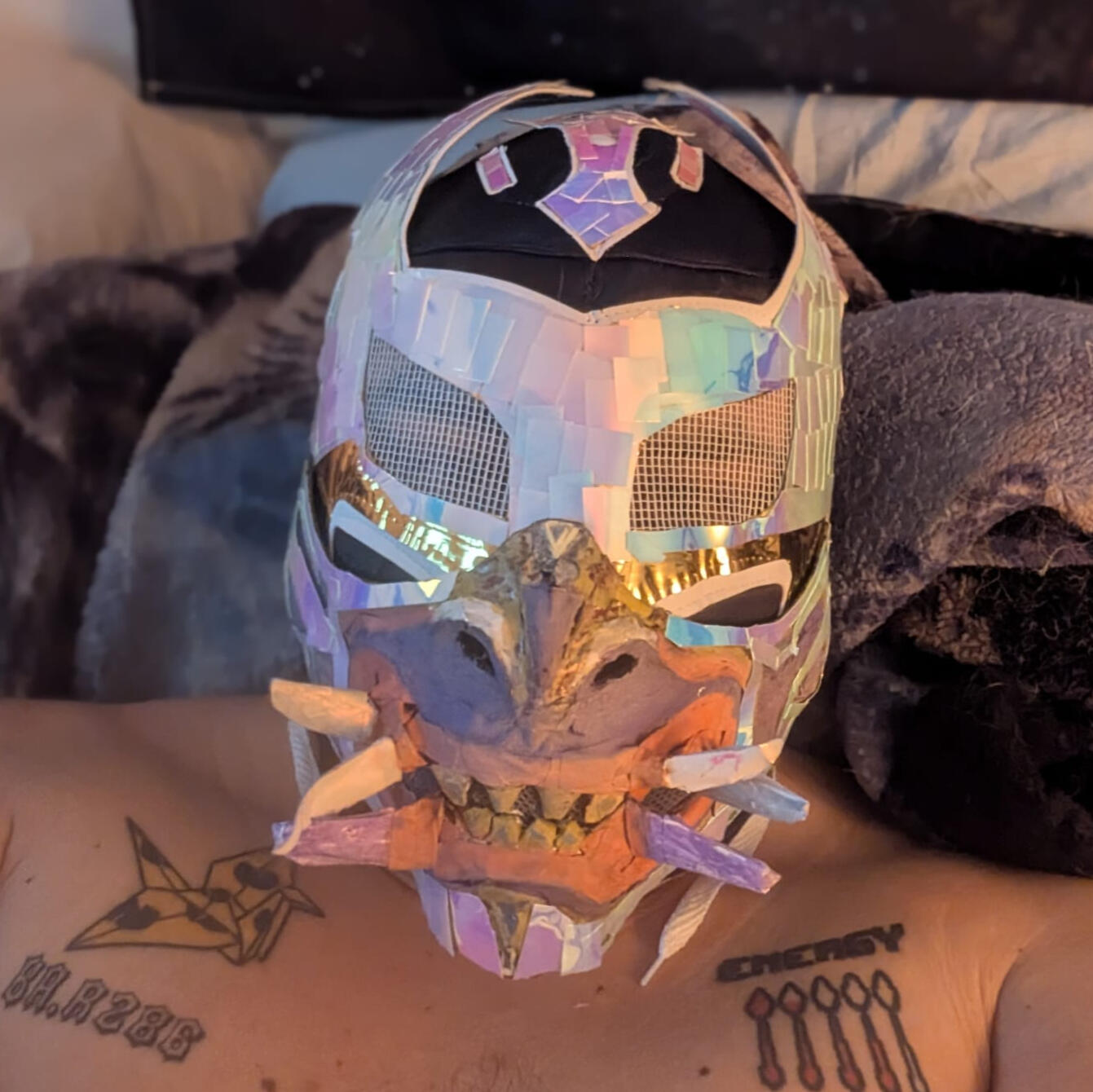 Baeond Rahysuz Image of The architect and creator of Barrio Conscious Spiritualism. He is wearing a black and yellow bandana covering his face and is wearing a football jersey #87